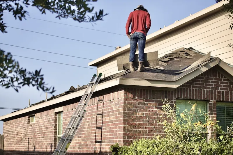 Professional roofer working on a residential roof in City Point